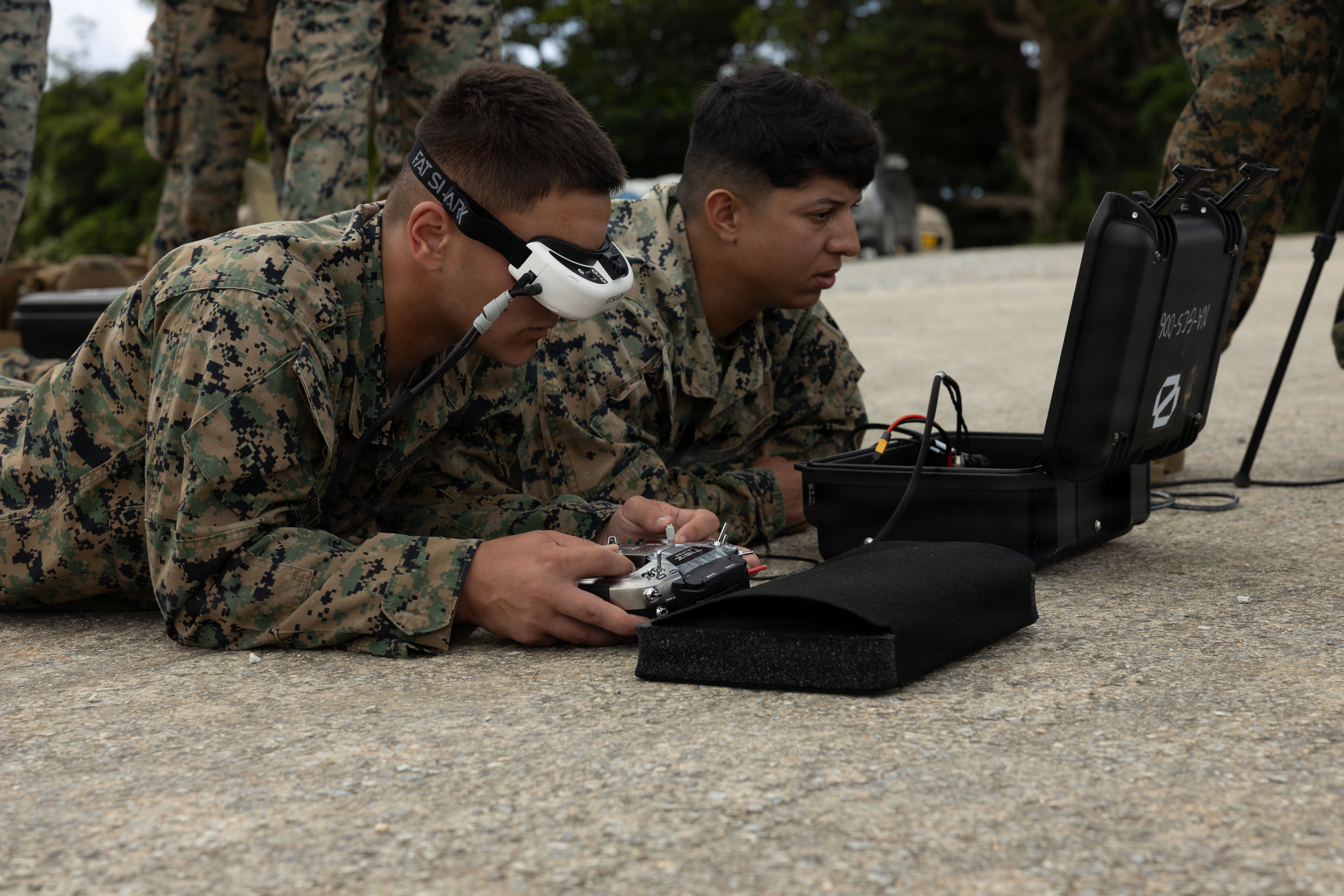 U.S. Marine Corps Lance Corporal Gabriel Demopoulos (left) and Corporal Humberto Castro both with 3rd Battalion, 7th Marine Regiment, forward deployed with 4th Marine Regiment, 3rd Marine Division as a part of the Unit Deployment Program, fly Neros Archer first-person view drones on Camp Schwab, Okinawa, Japan, May 22, 2026. This training sharpened their ability to operate advanced FPV drones that provide reconnaissance and precision strike capabilities. (Photo by U.S. Marine Corps Lance Cpl. Haley Munoz)